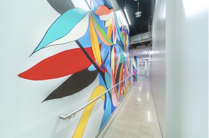 a hallway with a colorful mural on the wall