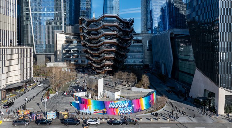 a large multi-tiered building with a colorful sign in the middle